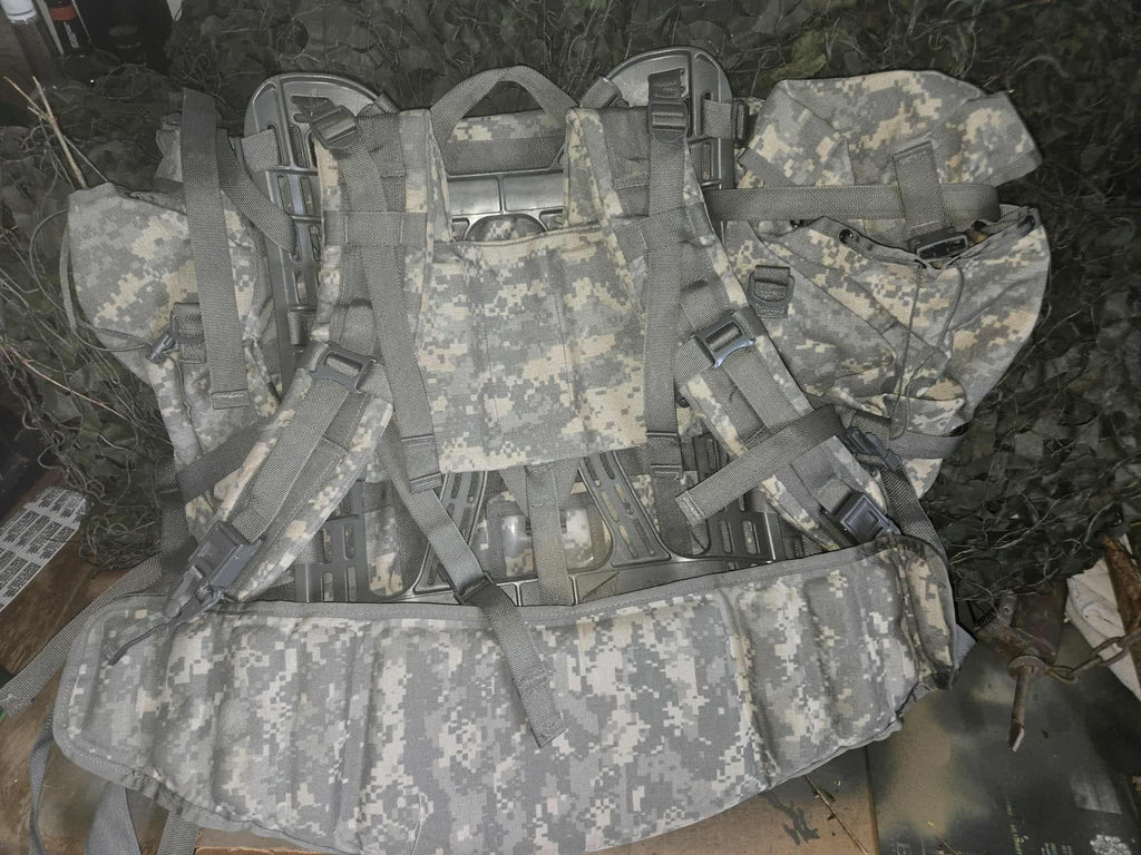Camouflage tactical vest with straps on a grassy background