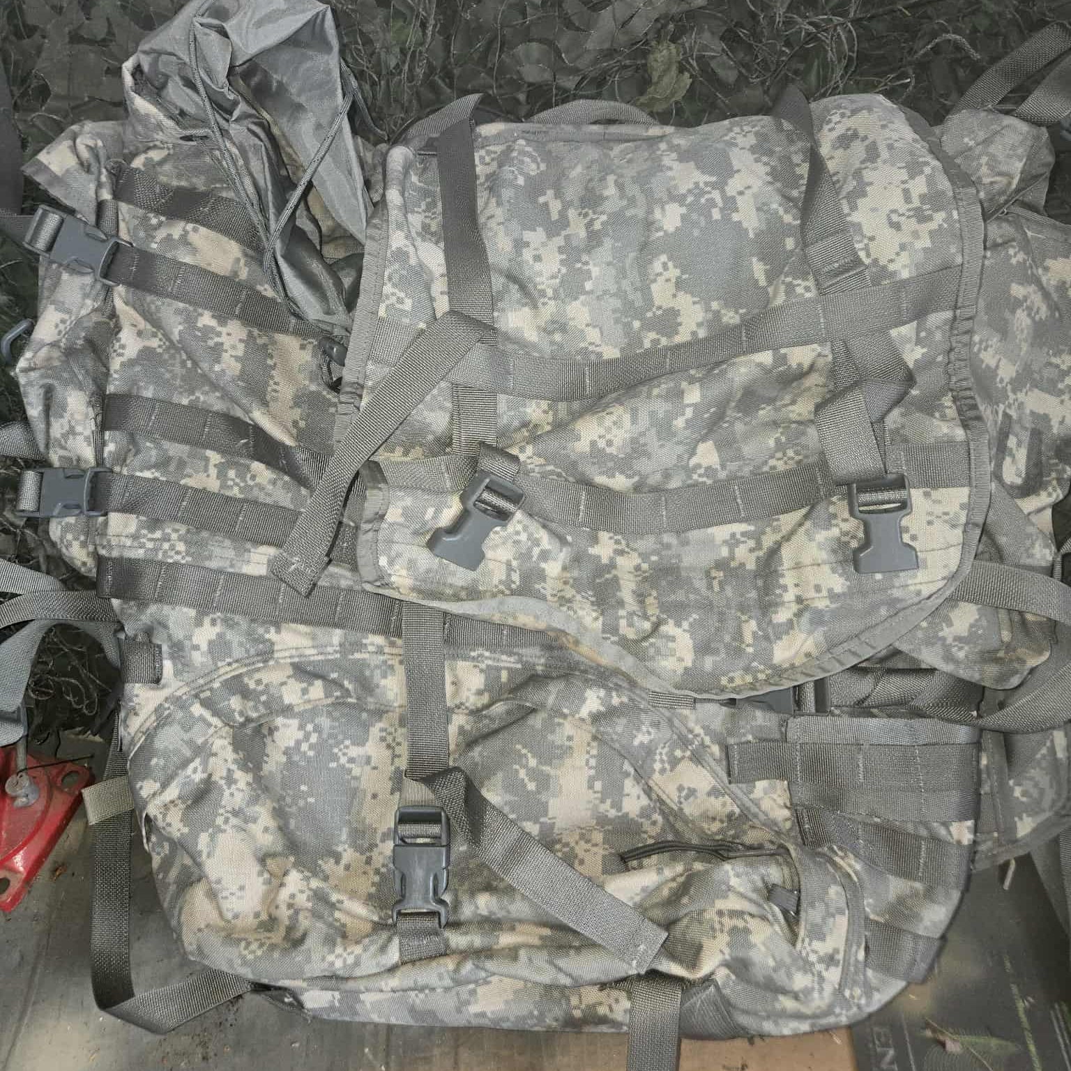 Camouflage backpack with ACU pattern on a wooden surface