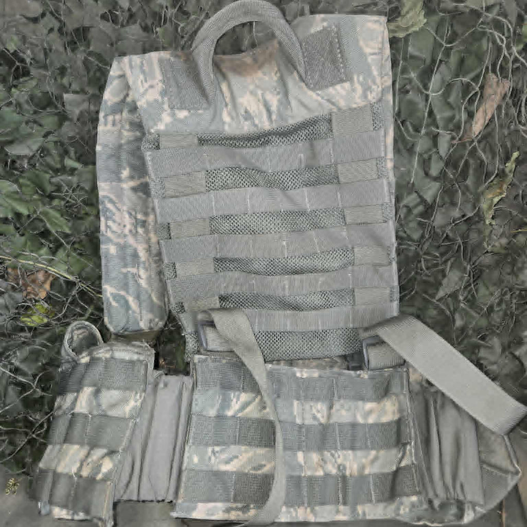 Tactical vest with UCP camouflage pattern on a grassy background