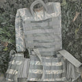 Tactical vest with UCP camouflage pattern on a grassy background